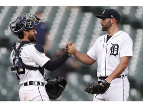 Detroit Tigers starting pitcher Michael Fulmer (32) celebrates with catcher Eric Haase (13) after a 5-3 win against the Chicago White Sox at Comerica Park on Tuesday.