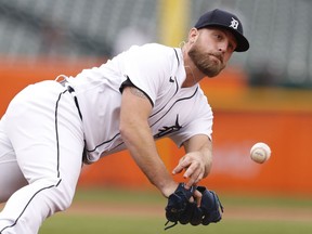 Detroit Tigers relief pitcher Ian Krol makes a diving throw to first base but commits a throwing error on a ball hit by Chicago White Sox designated hitter Yoan Moncada (not pictured) during the sixth inning at Comerica Park. Moncada reaches second base.