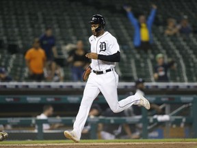 Detroit Tigers right fielder Victor Reyes scores the winning run on a double by center fielder Derek Hill (not pictured) against the Milwaukee Brewers during the eleventh inning at Comerica Park.