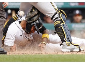 Detroit Tigers second baseman Harold Castro slides in safe at home ahead of the tag by Milwaukee Brewers catcher Manny Pina in the fifth inning at Comerica Park.
