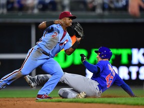 Philadelphia Phillies infielder Jean Segura turns a double play over Chicago Cubs outfielder Trayce Thompson in the ninth inning at Citizens Bank Park.