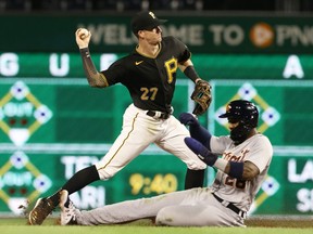 Pittsburgh Pirates shortstop Kevin Newman throws to first base to turn a double play over Detroit Tigers shortstop Niko Goodrum during the sixth inning at PNC Park.