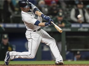 Seattle Mariners right fielder Mitch Haniger (17) hits a three run home run against the Oakland Athletics during the fourth inning at T-Mobile Park in Seattle on Sept. 27, 2021.