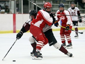 Leamington Flyers' Colton O'Brien (5) hits Chatham Maroons' David Brown (89) during an exhibition game in Chatham on Sunday. The Maroons won 5-4.