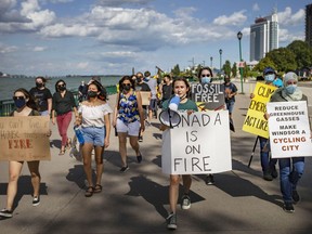 Climate activists protest along the riverfront to demand more be done on climate change as we head towards a federal election, on Wednesday, September 8, 2021.