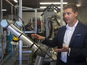 DuroByte Inc. vice president, Curtis Laurie, gives a demonstration of a newly built collaborative robot, on Thursday, September 9, 2021.  The robot can work safely side-by-side with a worker in a range of industries such as automotive or agriculture.