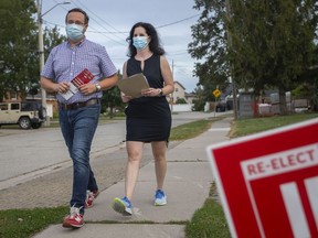 Windsor-Tecumseh incumbent MP Irek Kusmierczyk walks with his wife Shauna in Windsor's Forest Glade neighbourhoods before polls close on Sept. 20, 2021.