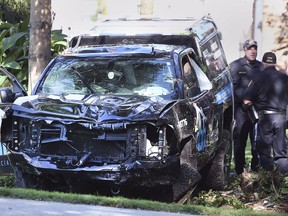 Officers with the Ontario Provincial Police investigate a fatal collision between a truck and a pedestrian on Heritage Road in Kingsville on Sept. 6, 2021.
