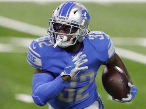 Detroit Lions running back D'Andre Swift runs the ball during the first quarter against the Washington Football Team at Ford Field.