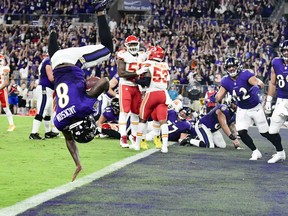 Baltimore Ravens quarterback Lamar Jackson flips into the end zone for  a fourth quarter touchdown  against the Kansas City Chiefs at M&T Bank Stadium.