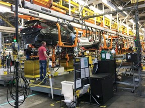 FILE PHOTO: Workers assemble Chevy Bolt EV cars at the General Motors assembly plant in Orion Township, Michigan, U.S. November 4, 2016.