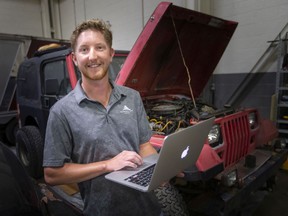 Patrick Thompson, business development leader at Ettractive, is pictured with two old Jeeps being retrofitted into electric and autonomous vehicles, on Tuesday, Sept. 14, 2021.