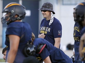 Head coach J.P. Circelli, in hat, puts his team through its paces as the Windsor Lancers prepare for Saturday's OUA football opener in Waterloo.