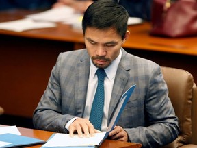 Philippine Senator and boxing champion Manny Pacquiao reads his briefing materials as he prepares for the Senate session in Pasay city, Metro Manila, Philippines September 20, 2016.