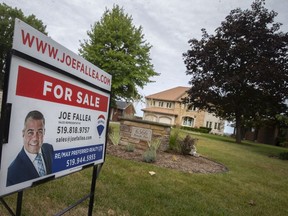 A 'for sale' sign is seen on the lawn of a home on Riverside Drive East in Riverside, on Friday, September 3, 2021.