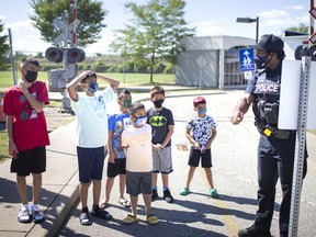 Const. Jamie Adjetey-Nelson leads a group of children on a back-to-school safety lesson at the Children's Safety Village on Thursday, September 2, 2021.