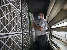 Vince Laframboise, building system officer with the Greater Essex County District School Board, checks out filters in the air handling unit at the Talbot Trail Elementary School in Windsor on Friday, September 10, 2021.