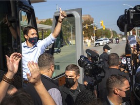 Cheers and jeers. Liberal Leader Justin Trudeau gives a thumb's up as he departs from a campaign stop at the University of Windsor on Friday, Sept. 2021.  Surrounding him were a group of supporters and protesters.