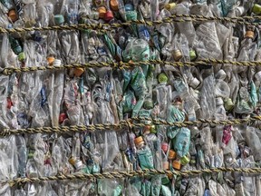 Plastic bottles are compressed into a bale at Asei plastic recycling company on November 5, 2020 in Kasama, Japan.