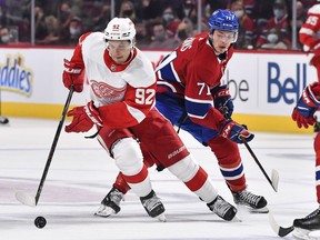 Vladislav Namestnikov of the Detroit Red Wings skates the puck against Jake Evans of the Montreal Canadiens during the third period at Centre Bell on October 23, 2021 in Montreal, Canada. The Canadiens won 6-1.