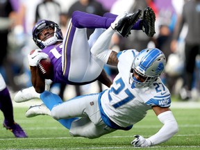Dede Westbrook of the Minnesota Vikings is hit by Bobby Price of the Detroit Lions during a punt return in the fourth quarter at U.S. Bank Stadium on Sunday.
