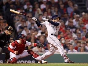Michael Brantley of the Houston Astros hits a single that scored Jose Altuve against the Boston Red Sox in the seventh inning of Game Five of the American League Championship Series at Fenway Park on October 20, 2021 in Boston, Massachusetts.