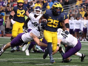 Hassan Haskins of the Michigan Wolverines runs for a second half touchdown against the Northwestern Wildcats at Michigan Stadium on October 23, 2021 in Ann Arbor, Michigan. Michigan won the game 33-7.
