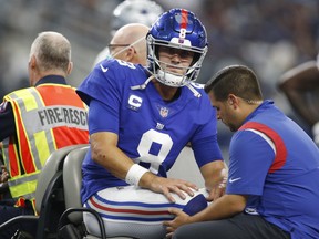 New York Giants quarterback Daniel Jones leaves the field on a cart with an injury in the second quarter against the Dallas Cowboys.