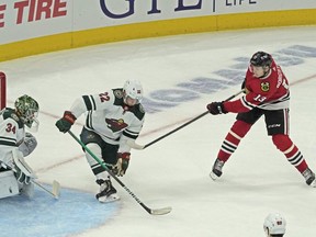 Blackhawks left wing Henrik Borgstrom (right) scores a goal on Wild goaltender Kaapo Kahkonen during the first period of a pre-season game at the United Center in Chicago, Saturday, Oct. 9, 2021.