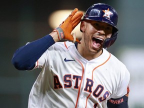 Carlos Correa of the Astros reacts after hitting a solo home run during the seventh inning against the Red Sox during Game One of the American League Championship Series at Minute Maid Park in Houston, Friday, Oct. 15, 2021.