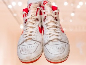 Pair of red and white Nike Air Ships, worn and autographed by Michael Jordan.