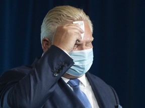 Ontario Premier Doug Ford attends a press briefing at the Queen's Park Legislature in Toronto on Friday, Oct. 15, 2021.