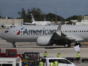 American Airlines jet pulls away from its gate at Miami International Airport.