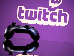 In this file photo taken on June 15, 2021, a gamepad is pictured as a screen displays the online Twitch plateform in Toulouse, southwestern France.