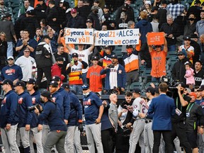 Houston Astros fans hold up signs after their win over the Chicago White Sox in game four of the 2021 ALDS at Guaranteed Rate Field. The Houston Astros won 10-1.