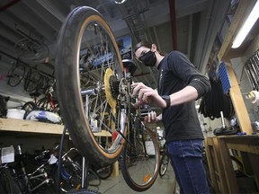 Bike Windsor Essex lead mechanic John Wigle works on a bicycle at The Bike Kitchen in Windsor on Wednesday, October 6, 2021.