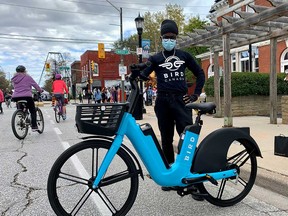 Franky, a representative of Bird Canada, shows off a Bird Bike in Windsor's west end on Oct. 17, 2021.