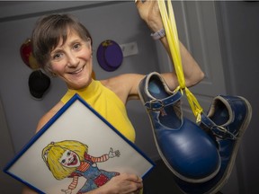 Carol Crooks, aka CLaroL the CLown, pictured in her 'clown room' on Tuesday, Oct. 5, 2021,  hangs top her clown shoes for the last time as she retires CLaroL after 35 years.