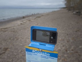 A smartphone Coastie cradle station is seen at the Northwest Beach at Point Pelee National Park, on Wednesday, Oct. 27, 2021.  The aim of the coastie is for visitors to take a photo of the coast using their smartphones to help Parks Canada monitor coastal changes over time.