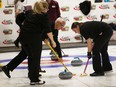 TECUMSEH, ON. Thursday, Oct. 14, 2021 -- Phil Denis and daugher Laura Beneteau, members of the Beach Grove curling team, sweep during the Ontario Mixed Curling Championship at Beach Grove Golf and Curling Club in Tecumseh on Thursday, Oct. 14, 2021.