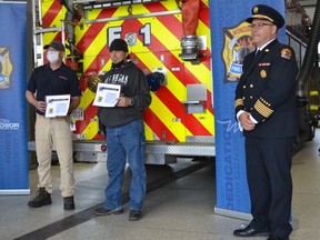 Dave Murdoch, from left, and James Johnson display their Citizen Citations, awarded Wednesday, Oct. 6, 2021, by Fire Chief Stephen Laforet, on far right. The men were recognized for their heroic behaviour and help is saving lives during two separate fires.