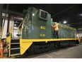 The Essex Terminal Railway's locomotive No. 105, which was built in 1956 and completing overhauled and repainted recently, is shown at the Windsor yard on Monday, October 25, 2021. Burton Dauncey, assistant chief mechanical officer at the ETR, does some last minute checks before leading it out of the facility.