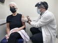 Sue Baerg receives her flu vaccine from Sebastian DiPietro an associate owner and pharmacist at the Shoppers Drug Mart at Howard and Tecumseh on Thursday, October 28, 2021.