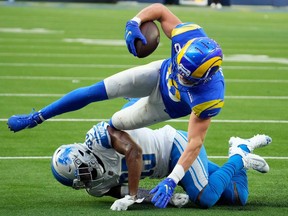 Los Angeles Rams wide receiver Cooper Kupp  runs over Detroit Lions running back D'Andre Swift to score a touchdown in the second half at SoFi Stadium.