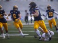 University of Windsor's Liam Hoskins returns an interception to set up a Lancer field goal in the first quarter of OUA football between the Lancers and the Guelph Gryphons at Alumni Field on Saturday, Oct. 9.