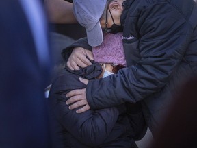 The son of an elderly fatal hit and run victim consoles his mother during a Windsor police press conference at the Windsor Police Training Centre on Friday, Oct. 22, 2021.  His father was struck and killed on Janette Avenue and Elliott Street West on Friday, Oct. 15, 2021.