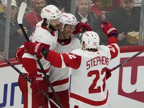 Detroit Red Wings right wing Carter Rowney (center) celebrates his goal against the Chicago Blackhawks during the second period at United Center.