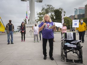 Approximately a dozen protesters gathered at the foot of Ouellette Avenue to participate in a provincewide rally to protest the state of long-term care in Ontario, on Monday, Oct. 4, 2021.