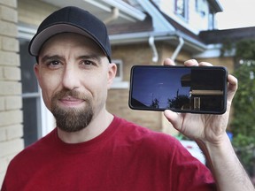 Shawn Bastien displays a video on his cell phone on Thursday, October 21, 2021 of a possible meteor that flew over the skies of Windsor recently.
