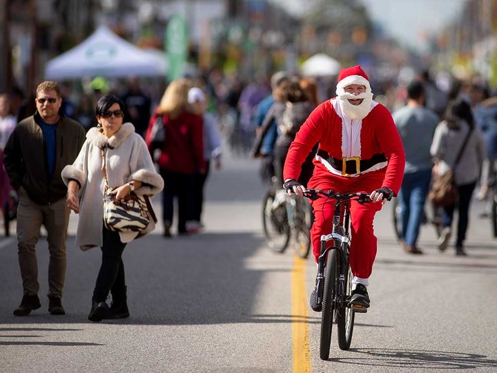  A cyclist dressed as Santa rides on Wyandotte Street East during Open Streets Windsor 2021. Photographed Oct. 17, 2021.